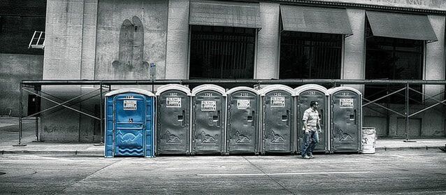 Picture of man leaving porta potty 